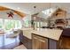 Bright kitchen with a large island, farmhouse sink, stainless steel appliances, and a view of the living area at 447 Lacy Rd, Canton, GA 30115