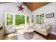 Cozy living area with large windows, natural light, and a view of the lush backyard at 447 Lacy Rd, Canton, GA 30115