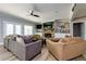 Cozy living room featuring a stone fireplace, built-in shelving, comfortable seating, and a ceiling fan at 447 Lacy Rd, Canton, GA 30115