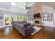 Spacious living room features a large sectional, tall windows, and a striking brick fireplace at 447 Lacy Rd, Canton, GA 30115