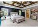 Bright main bedroom featuring a ceiling fan, wood beams, and sitting area with a bench at 447 Lacy Rd, Canton, GA 30115