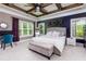 Comfortable main bedroom with natural light, a decorative accent wall, and a seating area at 447 Lacy Rd, Canton, GA 30115