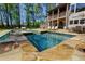 Backyard pool featuring stone accents and an attached jacuzzi and various seating areas at 447 Lacy Rd, Canton, GA 30115