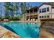 Large backyard swimming pool featuring stone accents, and stairs leading to a second story balcony at 447 Lacy Rd, Canton, GA 30115