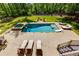 Aerial view of a stunning backyard with a refreshing pool, spa, and multiple lounge areas, ideal for relaxation at 447 Lacy Rd, Canton, GA 30115