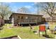 Cozy backyard with a wooden deck, chairs, and a well-maintained lawn at 857 Dill Sw Ave, Atlanta, GA 30310
