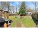 Spacious backyard with a wooden deck, seating area, and lush green lawn at 857 Dill Sw Ave, Atlanta, GA 30310