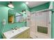 Bathroom showcasing double sinks and a glass-enclosed shower with modern fixtures at 857 Dill Sw Ave, Atlanta, GA 30310