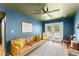 Bright living room featuring hardwood floors, a ceiling fan, and direct access to the backyard at 857 Dill Sw Ave, Atlanta, GA 30310