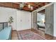 Stylish bedroom featuring exposed ceiling, a large wardrobe, and barn doors at 1791 Harper Nw St # H, Atlanta, GA 30318