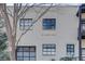 Exterior view of a building featuring a white brick facade, modern black-framed windows and street address at 1791 Harper Nw St # H, Atlanta, GA 30318