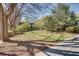 Exterior shot of condo building showing a grassy lawn surrounded by mature trees and shrubs in a park-like setting at 1791 Harper Nw St # H, Atlanta, GA 30318