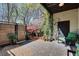 Cozy outdoor patio area with stone pavers, modern fencing, and lush greenery climbing the walls, perfect for relaxation at 1791 Harper Nw St # H, Atlanta, GA 30318