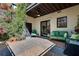 Private brick patio with lush greenery, comfortable seating, and a ceiling fan at 1791 Harper Nw St # H, Atlanta, GA 30318