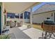 Inviting covered back porch with stone tile, outdoor furniture, and a green egg grill at 250 4Th St, Fayetteville, GA 30214