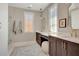 The well-lit bathroom features double vanities, decorative mirrors and carpet, and neutral-toned walls at 250 4Th St, Fayetteville, GA 30214