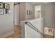Upstairs hallway has hardwood floors, art on the walls, and a modern railing and barn door at 250 4Th St, Fayetteville, GA 30214