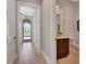 Hallway leading to a powder room with a view of the front yard from the arched transom over the front door at 250 4Th St, Fayetteville, GA 30214