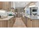 Gourmet kitchen with wood cabinetry, a large island, stainless steel appliances, and designer lighting fixtures at 250 4Th St, Fayetteville, GA 30214