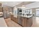 Open-concept kitchen featuring stainless steel appliances, a farmhouse sink, and a large island with seating at 250 4Th St, Fayetteville, GA 30214