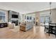 Spacious living room with fireplace, hardwood floors, comfortable seating, and ample natural light from large windows at 250 4Th St, Fayetteville, GA 30214