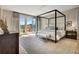 The main bedroom features a canopy bed, french doors to a deck, and soothing neutral tones at 250 4Th St, Fayetteville, GA 30214