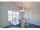 Bright dining area with a large window providing natural light over a dark wood table at 2593 Abbotts Glen Nw Dr, Acworth, GA 30101