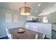 Cozy dining area features a rustic wood table, white chairs, and stylish lighting fixture at 2593 Abbotts Glen Nw Dr, Acworth, GA 30101