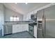 Modern kitchen featuring stainless steel appliances, white cabinets, and granite countertops at 2593 Abbotts Glen Nw Dr, Acworth, GA 30101