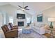 Cozy living room features a fireplace, ceiling fan, hardwood floors, and neutral decor for a relaxing atmosphere at 2593 Abbotts Glen Nw Dr, Acworth, GA 30101