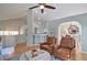Open-concept living room with hardwood floors, ceiling fan, comfortable seating, and dining area at 2593 Abbotts Glen Nw Dr, Acworth, GA 30101