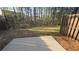 A serene backyard featuring a concrete pad and mature trees at 4440 Cedar Bridge Walk, Suwanee, GA 30024