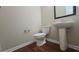 Half bathroom with sink and toilet and hard wood flooring at 4440 Cedar Bridge Walk, Suwanee, GA 30024