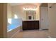 Spacious bathroom features a soaking tub, a double sink vanity with dark wood cabinets, and tile flooring at 4440 Cedar Bridge Walk, Suwanee, GA 30024