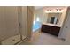 Bathroom with a glass shower, soaking tub, vanity with dark wood cabinets, and tile flooring at 4440 Cedar Bridge Walk, Suwanee, GA 30024