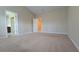 Spacious bedroom with neutral walls, plush carpeting, and access to the bathroom and hallway at 4440 Cedar Bridge Walk, Suwanee, GA 30024