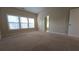 Primary bedroom featuring neutral colored carpet, walls and large windows for natural light at 4440 Cedar Bridge Walk, Suwanee, GA 30024