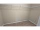 Walk-in closet with wire shelving and carpeted floor, offering ample storage space at 4440 Cedar Bridge Walk, Suwanee, GA 30024