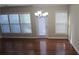 Well lit dining area with hardwood floors and a modern chandelier at 4440 Cedar Bridge Walk, Suwanee, GA 30024