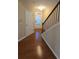 View of entryway, featuring hardwood floors, stairway, and a door with window at 4440 Cedar Bridge Walk, Suwanee, GA 30024