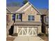 Charming brick townhome with a two-car garage and well-maintained landscaping in a desirable neighborhood at 4440 Cedar Bridge Walk, Suwanee, GA 30024
