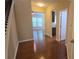 View down hallway, hardwood floors, neutral paint and view to the living room at 4440 Cedar Bridge Walk, Suwanee, GA 30024
