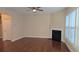 Bright living room with fireplace, ceiling fan, and many windows providing natural light at 4440 Cedar Bridge Walk, Suwanee, GA 30024