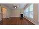 Bright living room with fireplace, ceiling fan, and many windows providing natural light at 4440 Cedar Bridge Walk, Suwanee, GA 30024