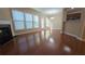 Spacious living room features gleaming hardwood floors, fireplace, and large windows at 4440 Cedar Bridge Walk, Suwanee, GA 30024