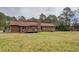 Spacious backyard showcasing the home's rear exterior, including a charming wooden deck and lush lawn at 5687 Highway 212, Covington, GA 30016