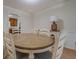 Classic dining room with a round table and six chairs, cabinet and lamp at 5687 Highway 212, Covington, GA 30016