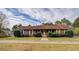 Charming one-story home with wood siding, mature landscaping, and a welcoming front porch at 5687 Highway 212, Covington, GA 30016