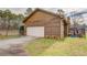Detached two-car garage with wood siding, a concrete driveway, and a convenient backyard deck at 5687 Highway 212, Covington, GA 30016