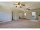 Large living room with neutral carpet, ceiling fans, and multiple entrances at 5687 Highway 212, Covington, GA 30016